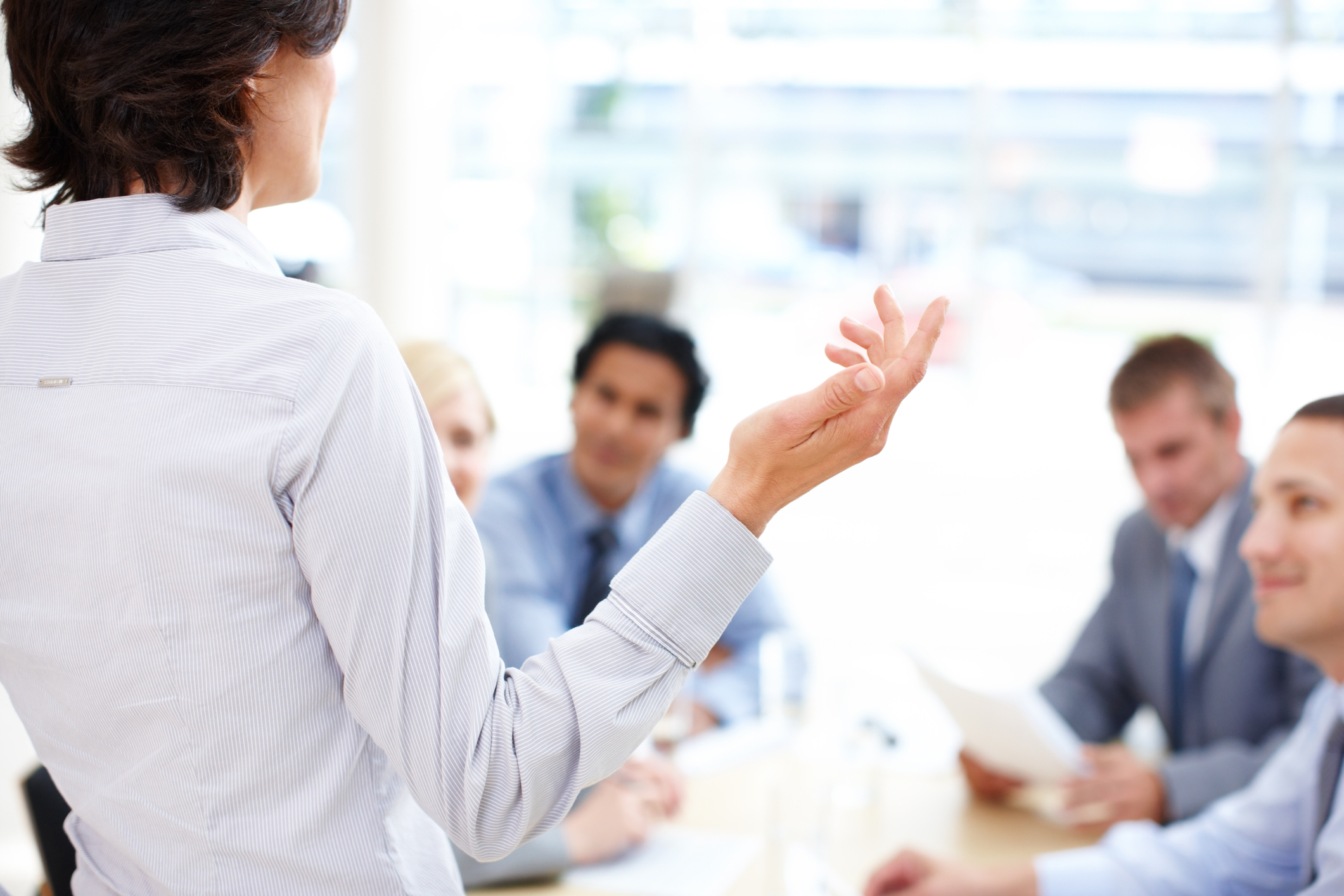 Woman speaking to a group of coworkers